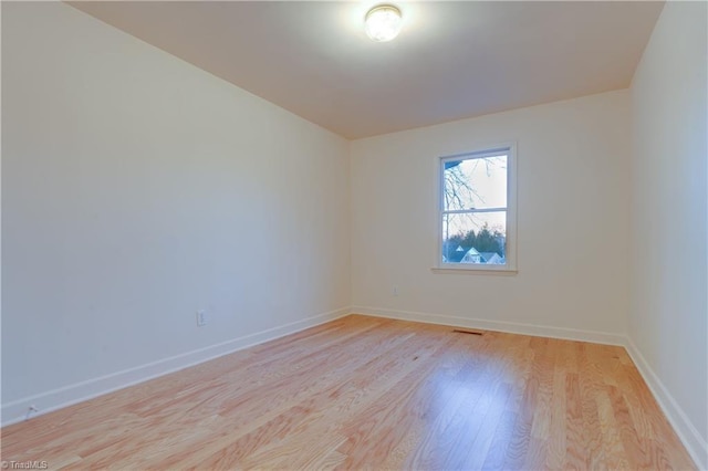 spare room with light hardwood / wood-style flooring