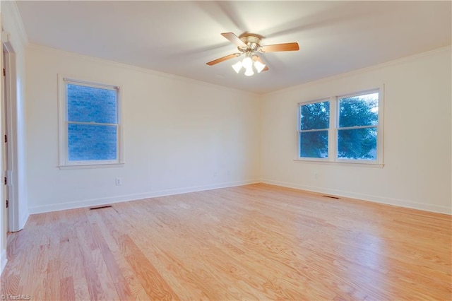 spare room featuring light hardwood / wood-style floors, ceiling fan, and ornamental molding