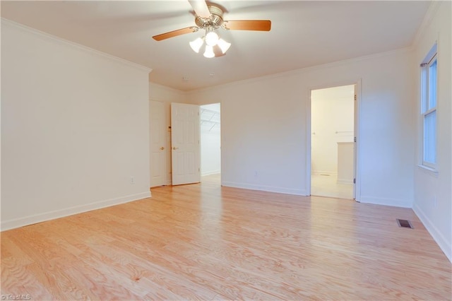 spare room featuring ceiling fan, light hardwood / wood-style floors, and ornamental molding