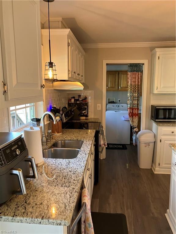 120 King Arthur Dr, King, NC 27021 - kitchen with white cabinetry, crown molding, a sink, washer / dryer, and black range with electric cooktop