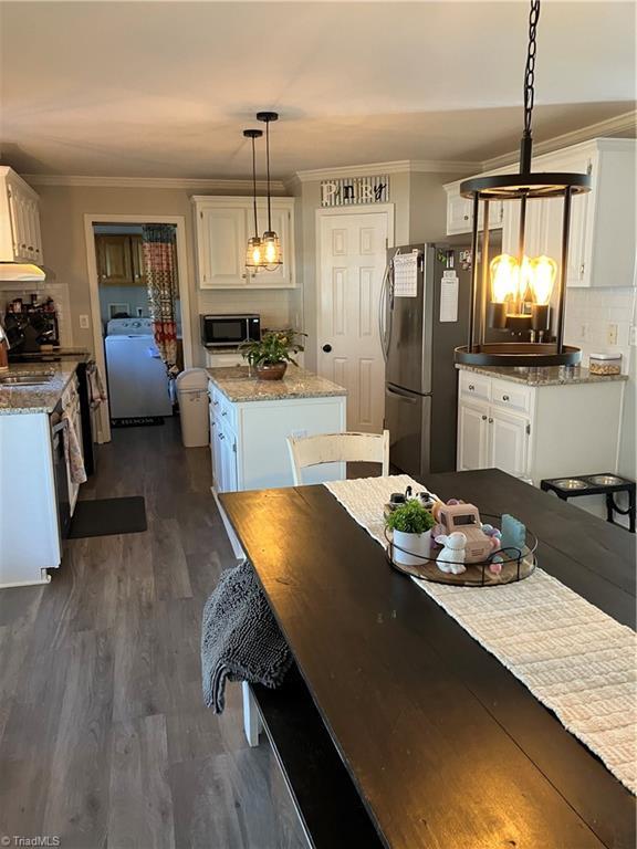120 King Arthur Dr, King, NC 27021 - kitchen featuring freestanding refrigerator, washer / clothes dryer, crown molding, and black microwave