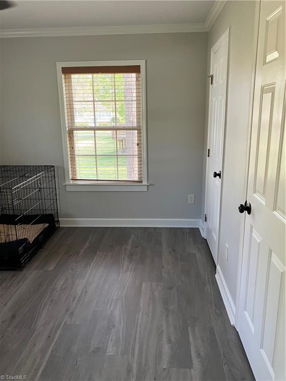 120 King Arthur Dr, King, NC 27021 - empty room featuring dark wood-style floors, baseboards, and ornamental molding