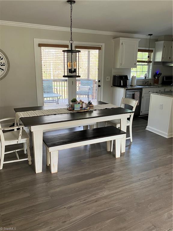 120 King Arthur Dr, King, NC 27021 - dining area featuring dark wood-type flooring, ornamental molding, and a notable chandelier