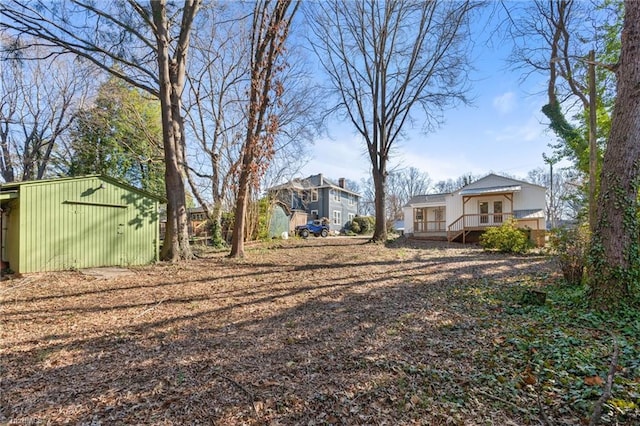 view of yard with an outbuilding and a wooden deck