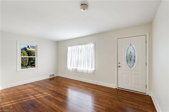 entrance foyer featuring visible vents, baseboards, and dark wood-style flooring