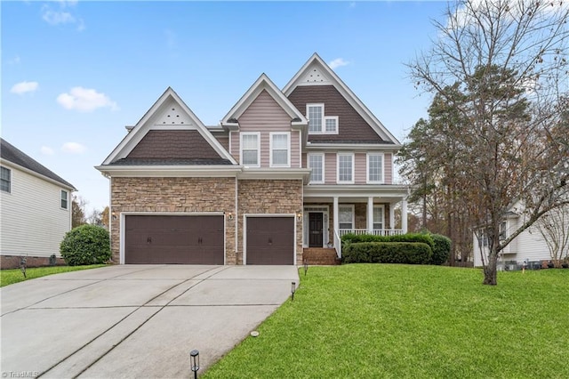 craftsman-style home featuring a front lawn, covered porch, and a garage