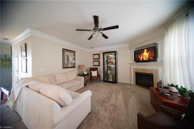 carpeted living room with ornamental molding and ceiling fan