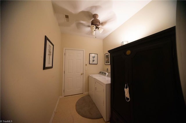 washroom featuring washing machine and dryer, cabinets, and ceiling fan