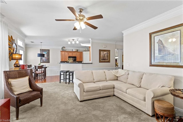 living room with crown molding and ceiling fan