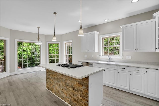 2101 Abbott Dr, Greensboro, NC 27455 - kitchen featuring appliances with stainless steel finishes, light wood-type flooring, light countertops, white cabinets, and recessed lighting