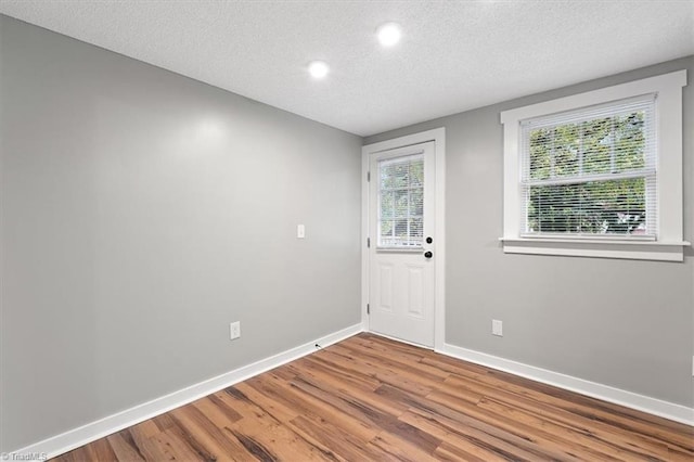 interior space featuring a textured ceiling and hardwood / wood-style flooring