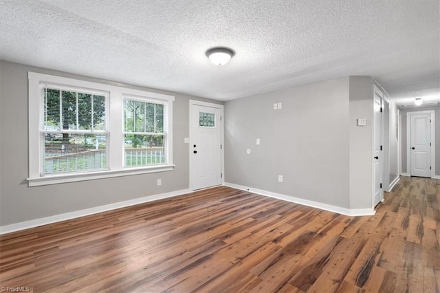 interior space featuring a textured ceiling and hardwood / wood-style flooring