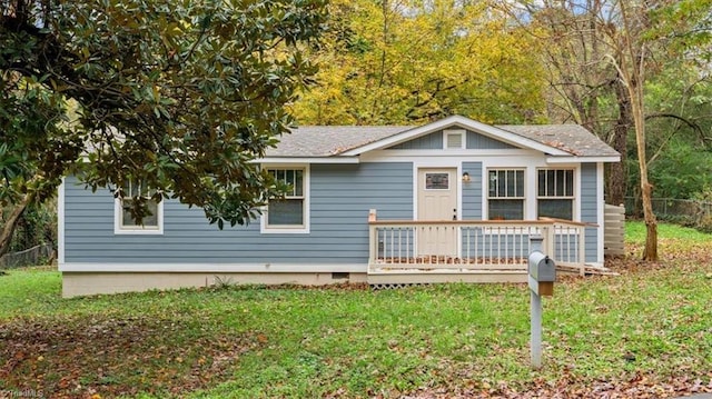 view of front of home featuring a front lawn and a deck