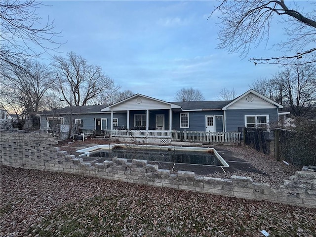 back of house featuring covered porch