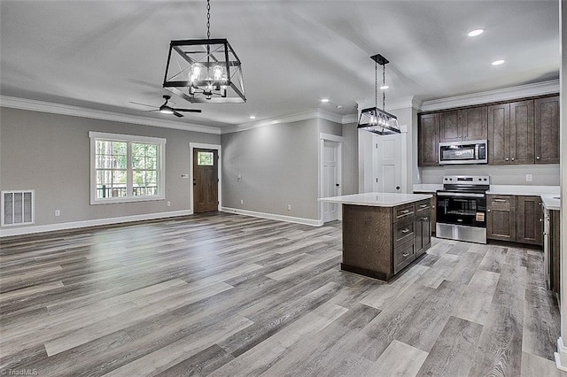 4503 Holly Leaf Rd, Ramseur, NC 27316 - kitchen featuring appliances with stainless steel finishes, a chandelier, ornamental molding, a kitchen island, and recessed lighting