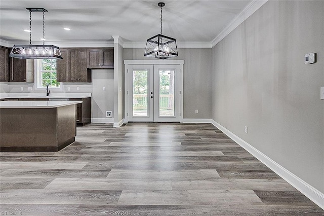 4503 Holly Leaf Rd, Ramseur, NC 27316 - kitchen featuring a chandelier, dark brown cabinetry, ornamental molding, light countertops, and french doors