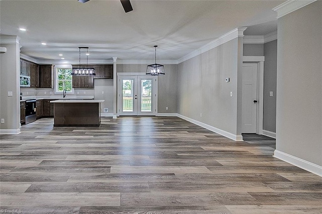 4503 Holly Leaf Rd, Ramseur, NC 27316 - kitchen featuring range with electric stovetop, dark brown cabinetry, crown molding, stainless steel microwave, and baseboards