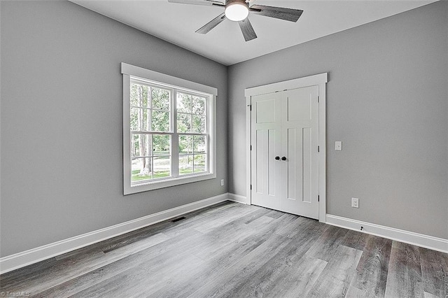 4503 Holly Leaf Rd, Ramseur, NC 27316 - unfurnished bedroom with wood finished floors, baseboards, and ceiling fan