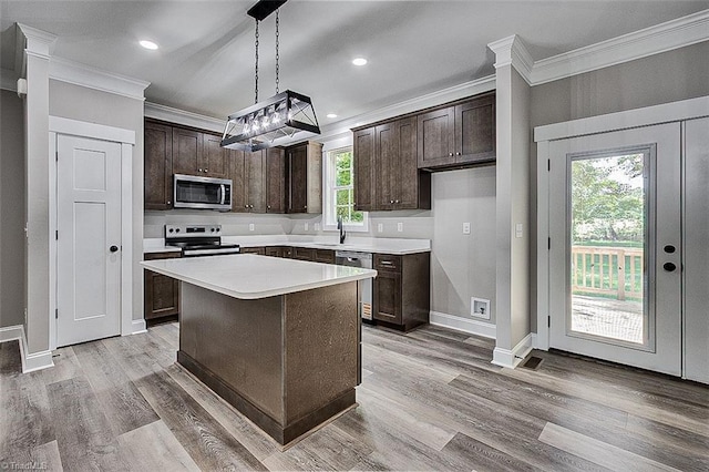 4503 Holly Leaf Rd, Ramseur, NC 27316 - kitchen with appliances with stainless steel finishes, crown molding, dark brown cabinetry, baseboards, and light countertops
