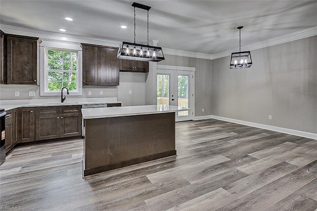 4503 Holly Leaf Rd, Ramseur, NC 27316 - kitchen featuring a sink, french doors, dark brown cabinetry, a chandelier, and crown molding