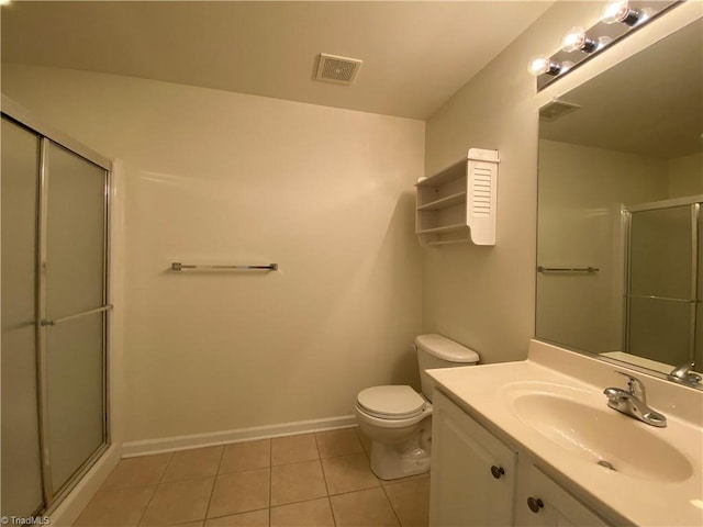 bathroom with tile patterned floors, toilet, a shower with shower door, and vanity