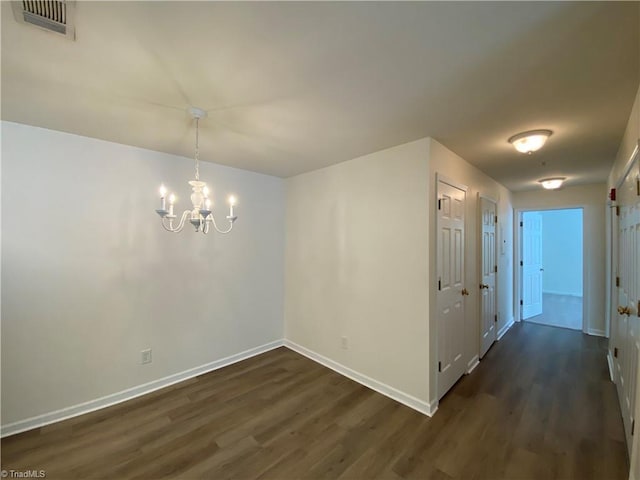 interior space with dark hardwood / wood-style flooring and a notable chandelier