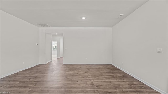 unfurnished room with hardwood / wood-style floors