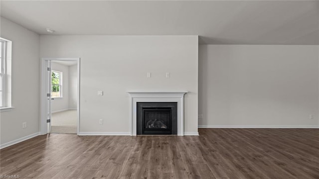 unfurnished living room with hardwood / wood-style flooring