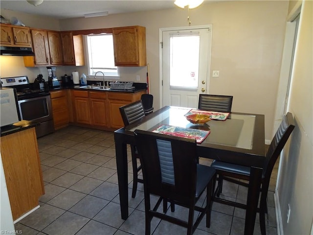 kitchen featuring tile patterned flooring, sink, and stainless steel electric range