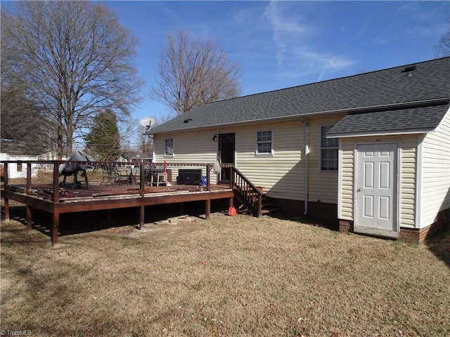 back of property featuring a yard and a deck