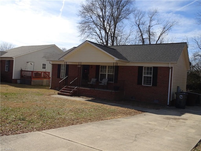 single story home with a front yard and covered porch