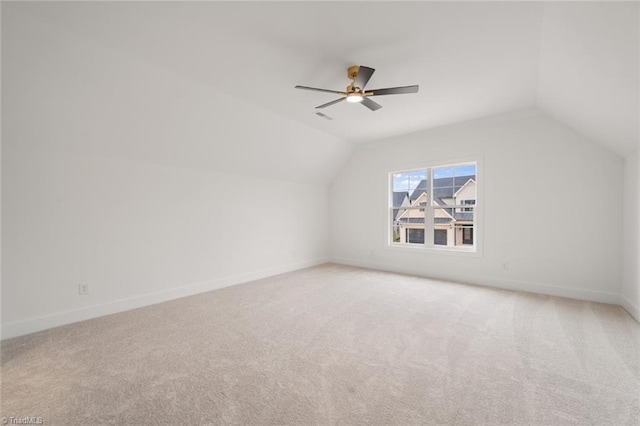 bonus room featuring visible vents, a ceiling fan, baseboards, light colored carpet, and vaulted ceiling