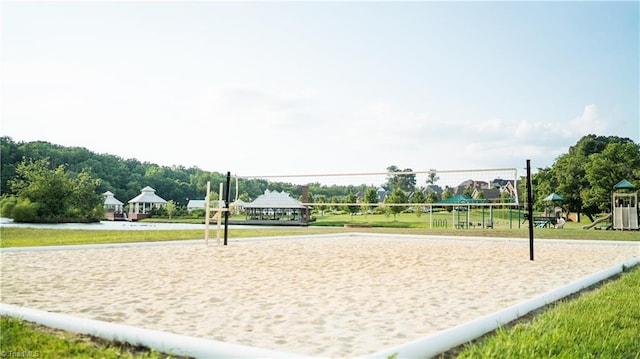 surrounding community featuring a yard and volleyball court