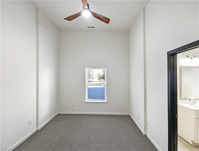 unfurnished room featuring carpet, visible vents, ceiling fan, and baseboards