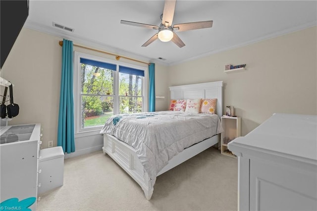bedroom with a ceiling fan, crown molding, light carpet, and visible vents