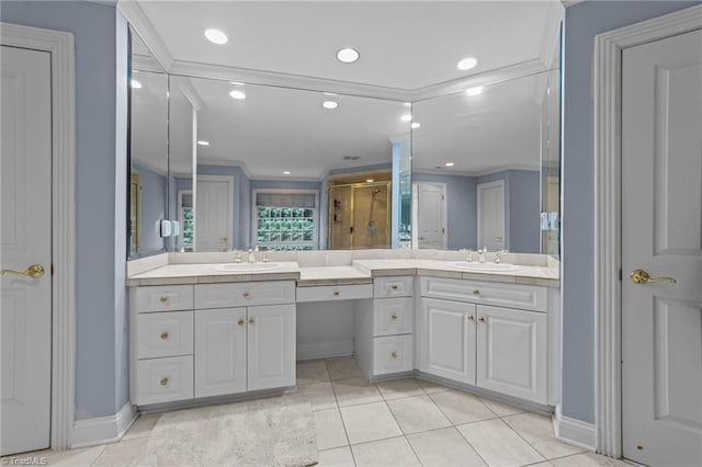 full bathroom featuring crown molding, tile patterned flooring, a stall shower, and vanity