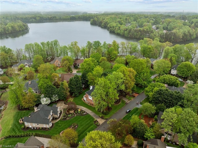 birds eye view of property with a water view, a residential view, and a wooded view