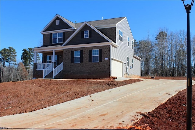 craftsman inspired home featuring covered porch and a garage