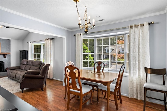 143 Chrisfield Cir, Winston-Salem, NC 27104 - dining area with a chandelier, wood finished floors, healthy amount of natural light, crown molding, and a textured ceiling