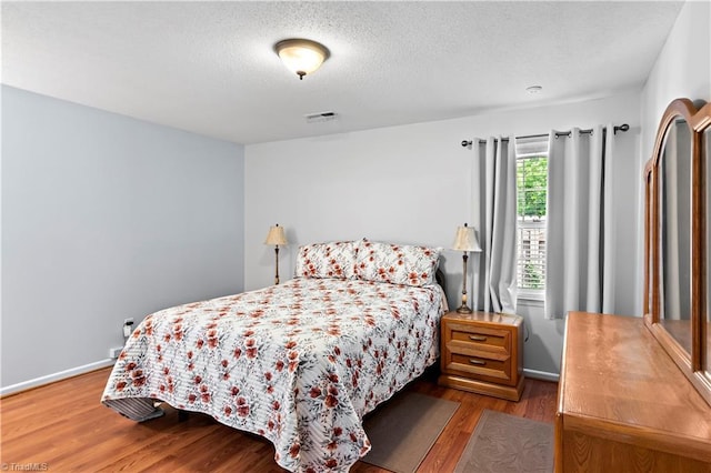143 Chrisfield Cir, Winston-Salem, NC 27104 - bedroom with wood finished floors, a textured ceiling, and baseboards