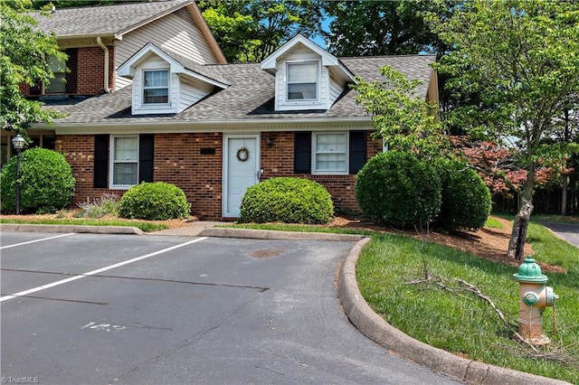 143 Chrisfield Cir, Winston-Salem, NC 27104 - view of front of home with brick siding, uncovered parking, and a shingled roof