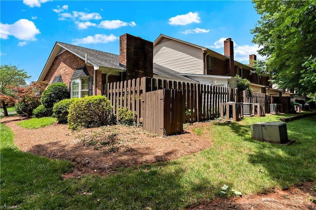143 Chrisfield Cir, Winston-Salem, NC 27104 - rear view of property with brick siding, a chimney, and cooling unit