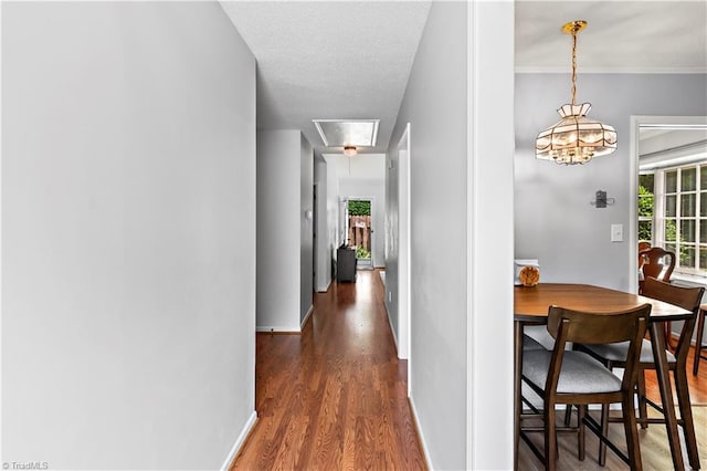 143 Chrisfield Cir, Winston-Salem, NC 27104 - corridor featuring wood finished floors, attic access, baseboards, and a chandelier
