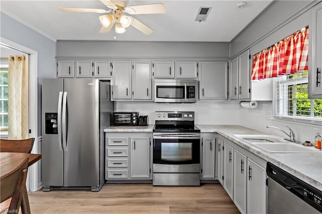 143 Chrisfield Cir, Winston-Salem, NC 27104 - kitchen featuring stainless steel appliances, a sink, crown molding, light countertops, and a ceiling fan