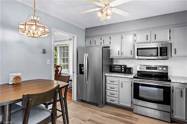 143 Chrisfield Cir, Winston-Salem, NC 27104 - kitchen featuring stainless steel appliances, light countertops, ornamental molding, ceiling fan, and light wood-style floors