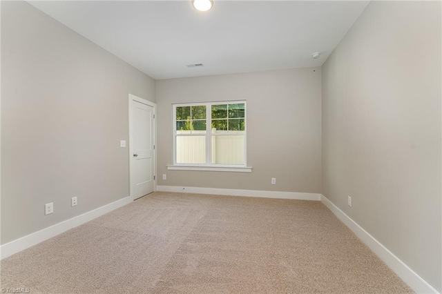 unfurnished room with light carpet