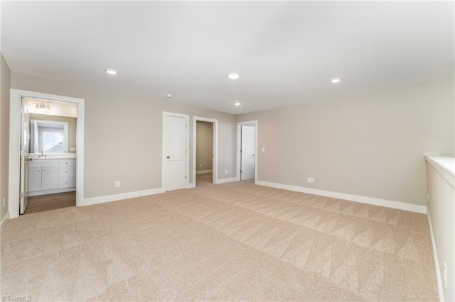 spare room featuring light colored carpet