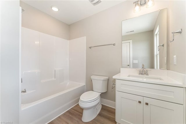 full bathroom featuring vanity, wood-type flooring, shower / washtub combination, and toilet