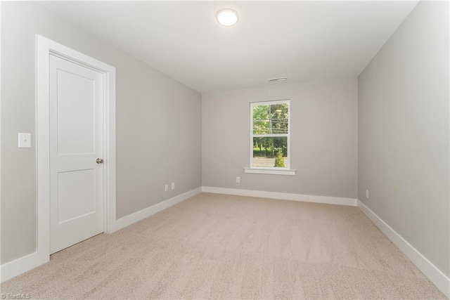 empty room featuring light colored carpet