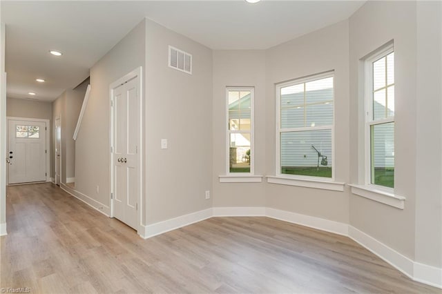 unfurnished room with light wood-type flooring